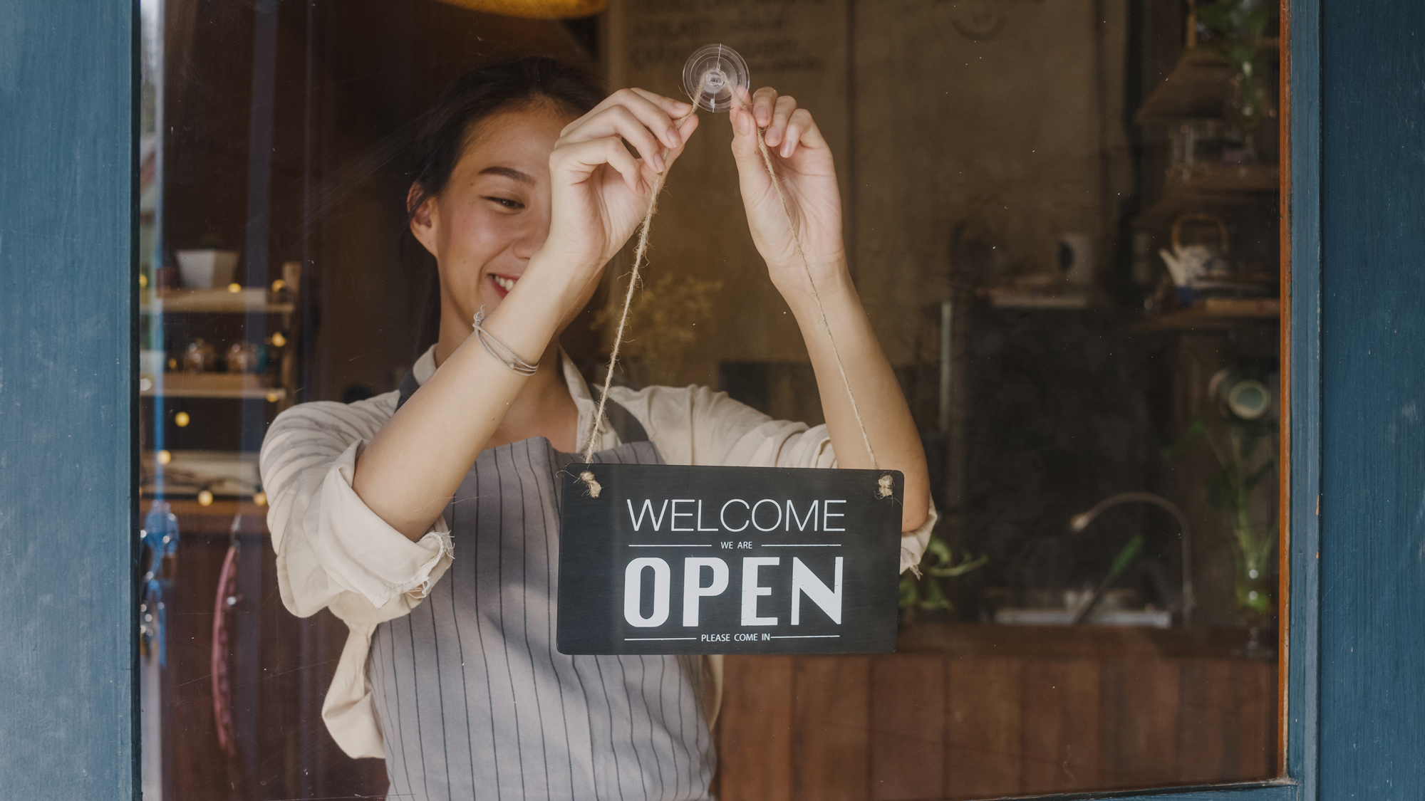 woman business owner opening her store