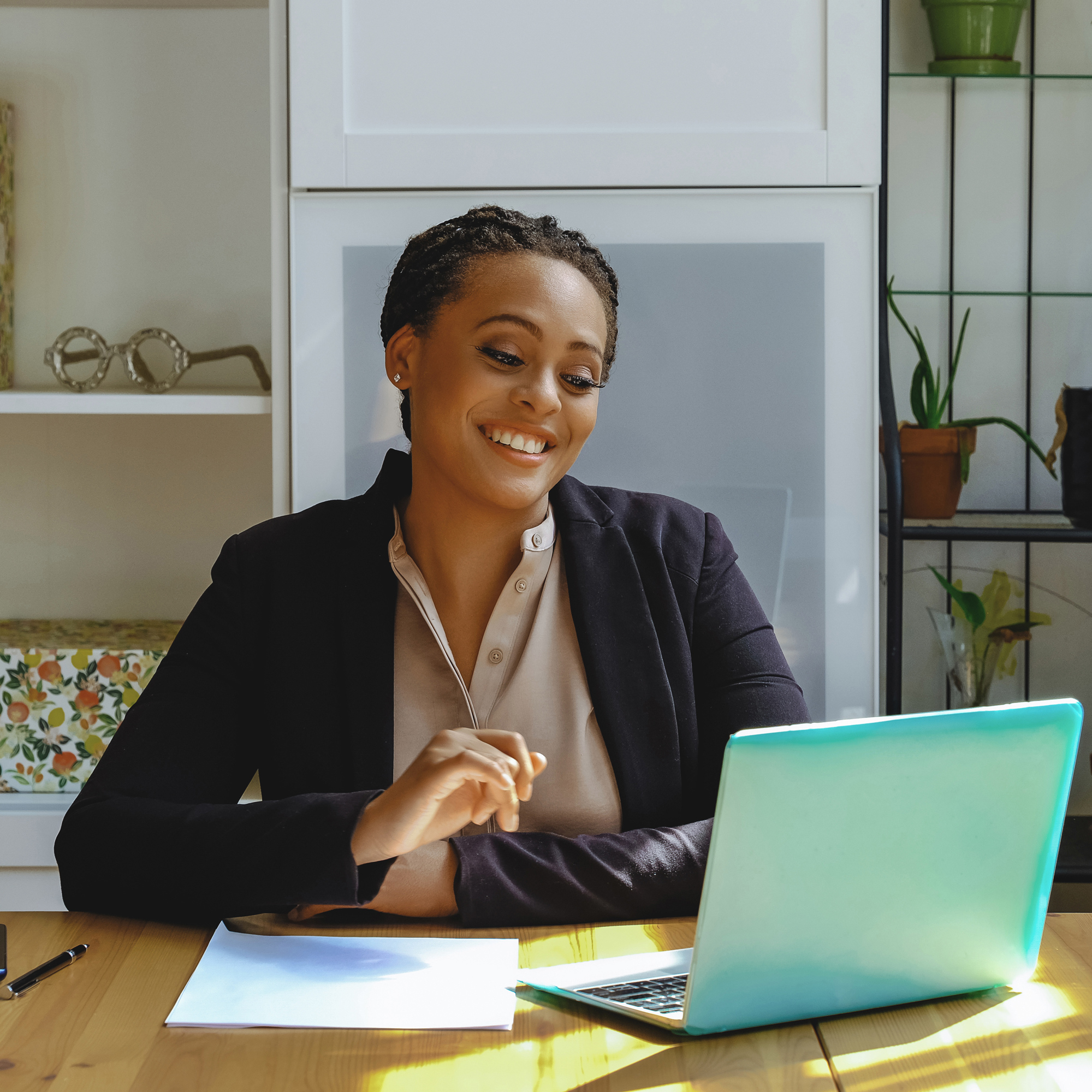 woman business owner looking at a laptop in her office
