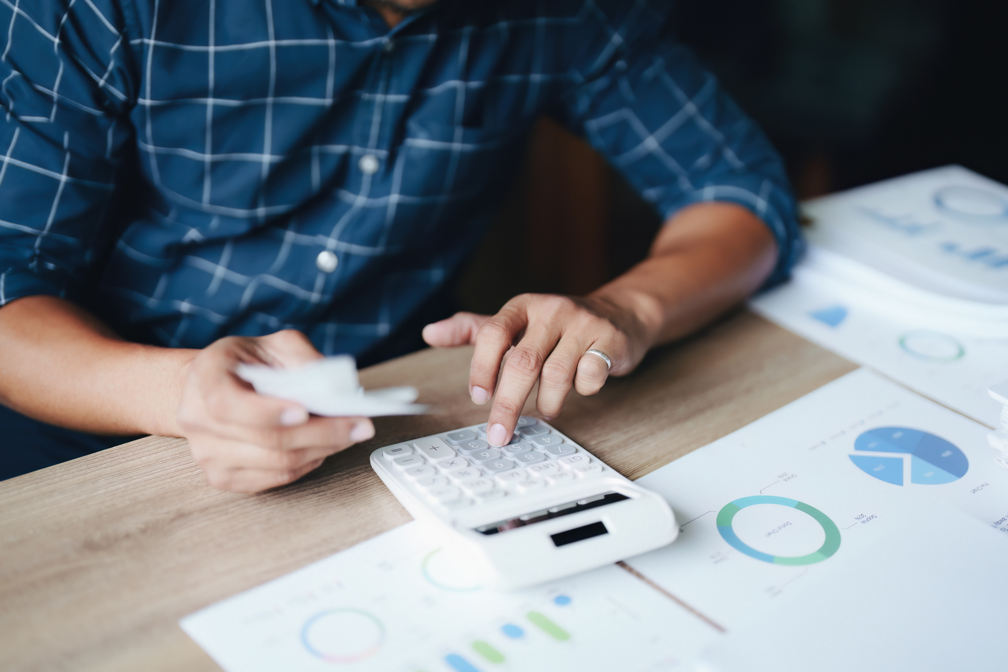financial advisor typing on calculator