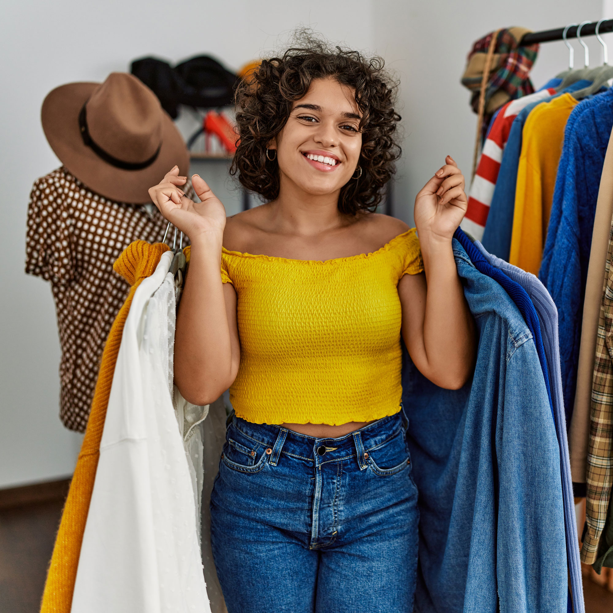 retail business owner woman holding clothing in her store